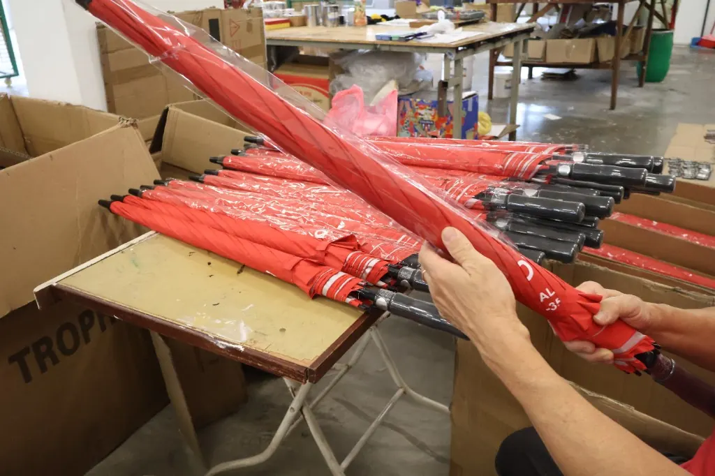 Quality check and packaging of branded umbrellas